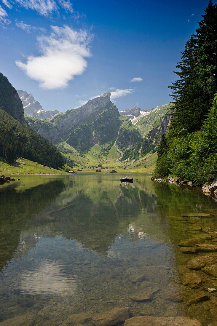 Reflection and boat on lake Seealpsee, Alpsteingebirge, Saentis, Appenzeller Land, Switzerland, Europe