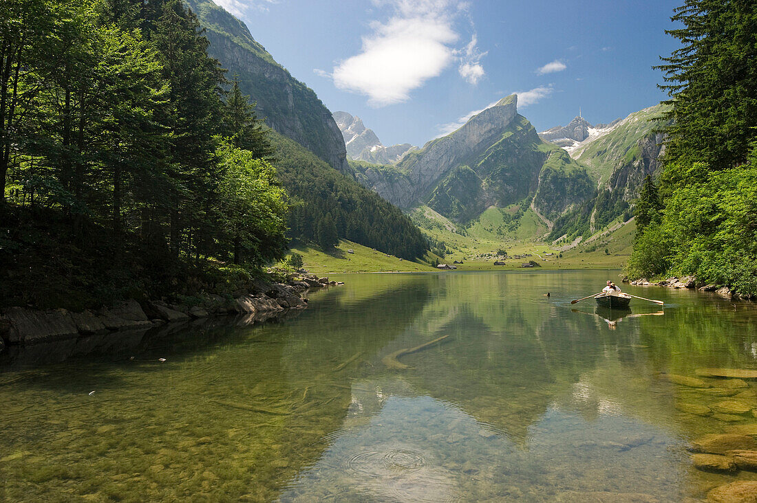 Reflection and boat on lake Seealpsee, Alpsteingebirge, Saentis, Appenzeller Land, Switzerland, Europe