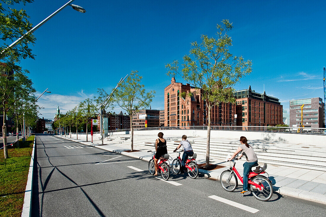 Cyclists, Internationales Maritimes Museum in background, HafenCity, Hamburg, Germany