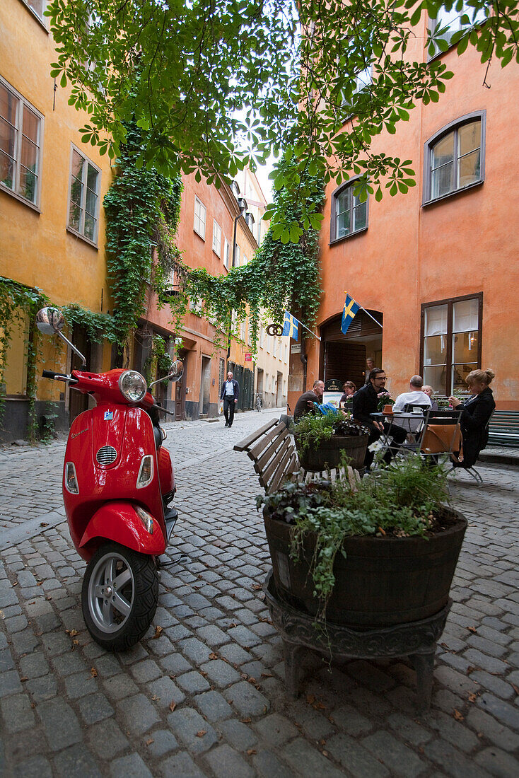 Roter Motorroller und bunte Häuser in der Gamla Stan Altstadt, Stockholm, Schweden, Europa