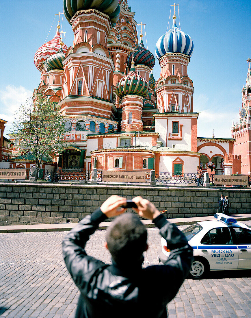 Tourist taking pictures of St. Basil's Cathedral with his cell phone, Moscow, Russia, Europe