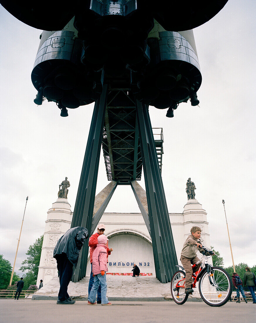 Visitors underneath booster rocket at All Russia Exibition Centre VVC, Moscow, Russia, Europe