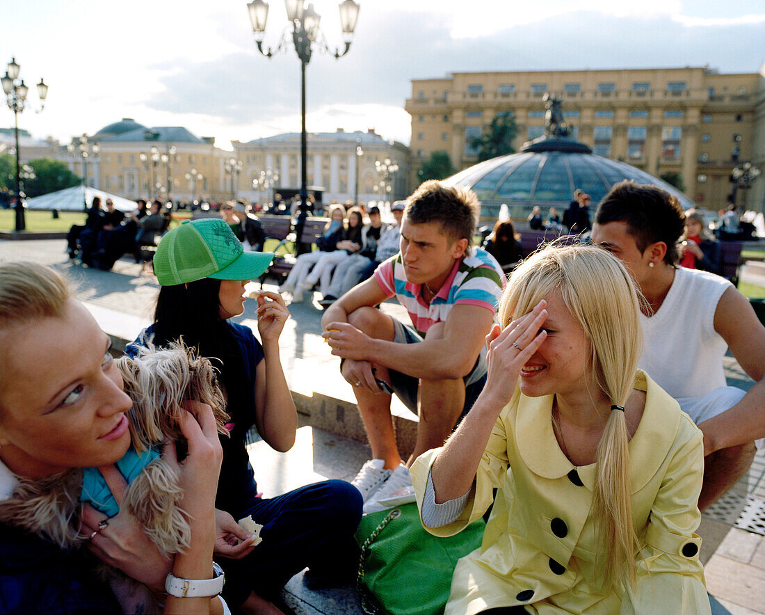 Teenage friends meeting up at Manege square, Moscow, Russia, Europe