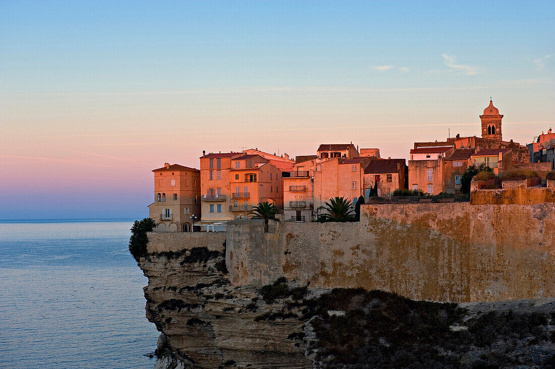 The first rays of sunlight hitting the medieval fortified town of Bonifacio, Bonifacio. Corsica. France.