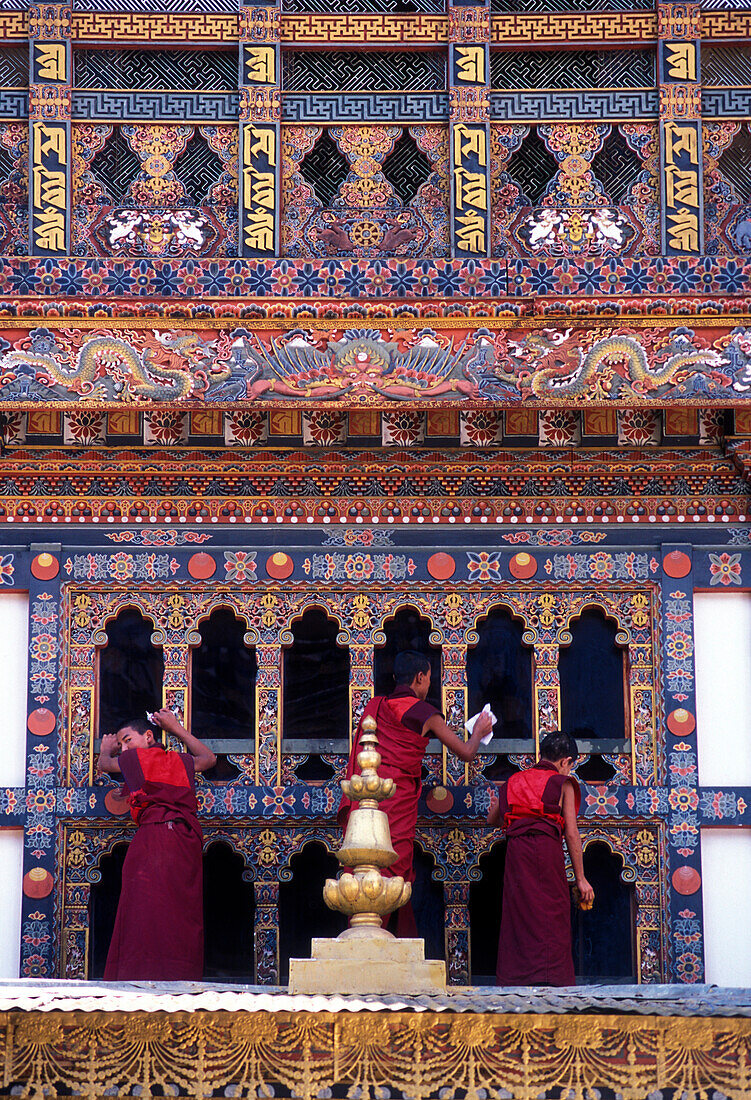 Monks cleaning windows at monastery, Punakha, Bhutan