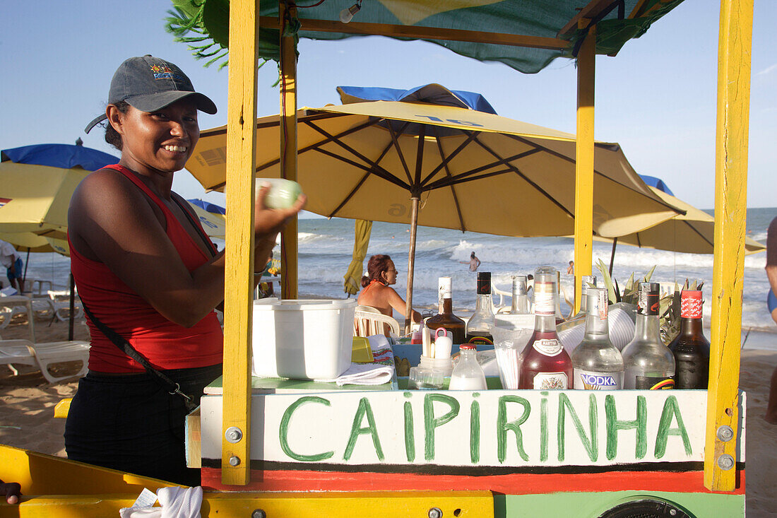 A woman selling Caipirinha from a mobile cart at a beach , Brazil