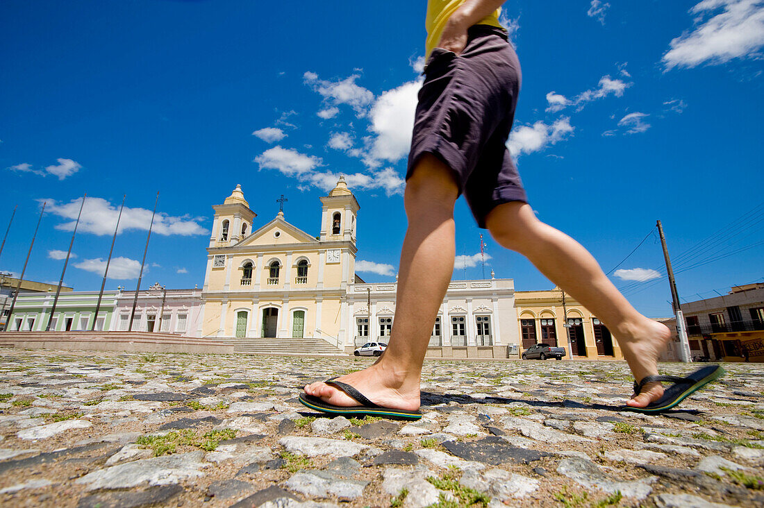 Girl passing by Church of Jaguarao, Brazil, South America