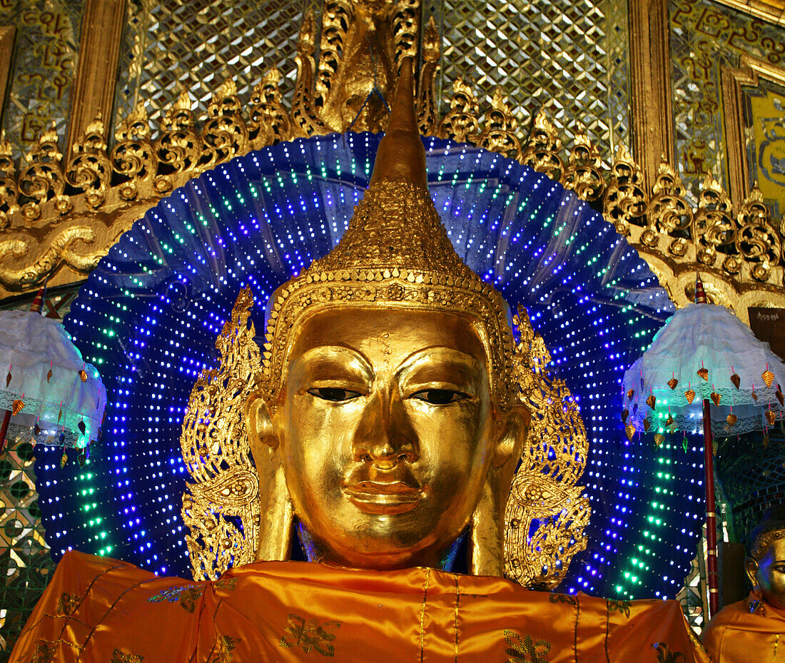 Golden statue of Buddha face, Shwedagon pagoda in Rangoon, Burma (Myanmar).
