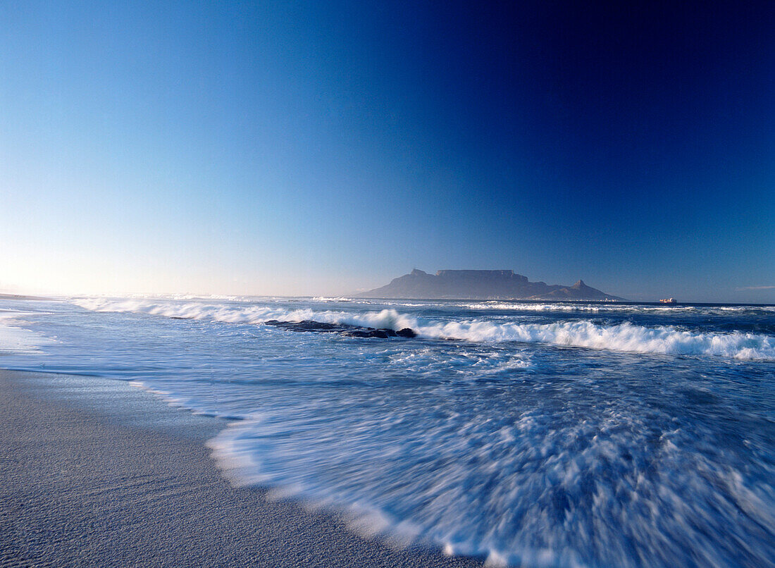 Looking over to Cape Town and Table Mountain at dawn seen from Blouberg Beach, blurred motion, South Africa