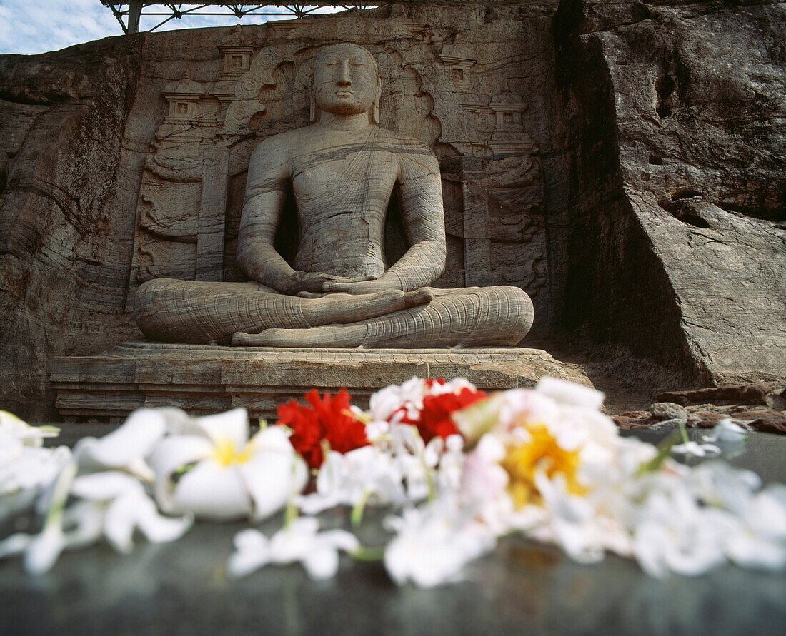 Seated Buddha and flower offerings, Polonnaruwa, North Central Province, Sri Lanka