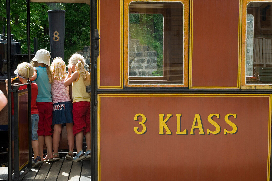 Children look on at the narrow-gauged railway at Mariefred, Sweden