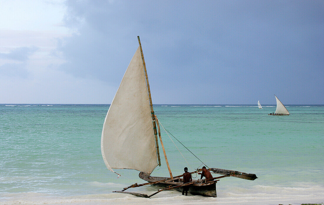 Men on dhow on the beach, Zanzibar, Tanzania