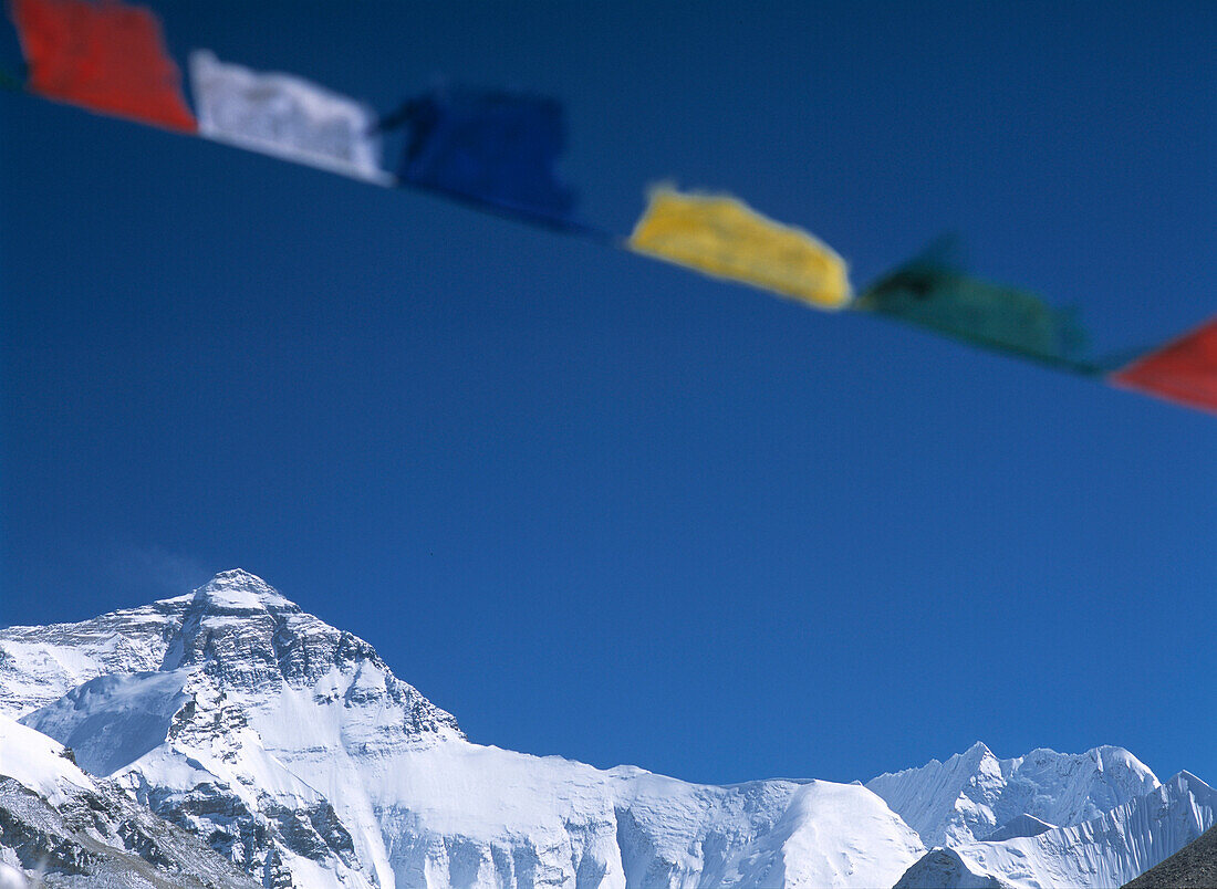 Prayer flags on hill above Base Camp, looking towards Mt. Everest, Tibet