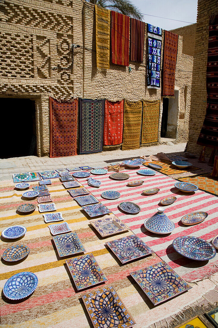 Plates and rugs laid out in market square, Tozeur, Tunisia
