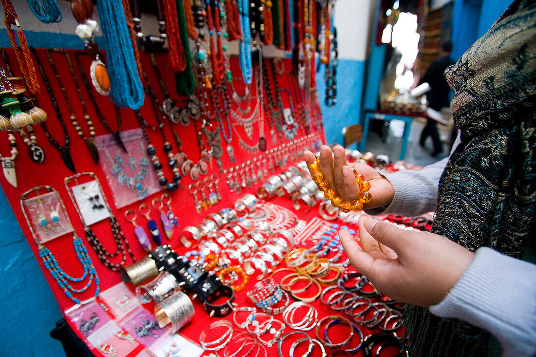 Female tourist looking at jewellery in souq, Tunis, Tunisia