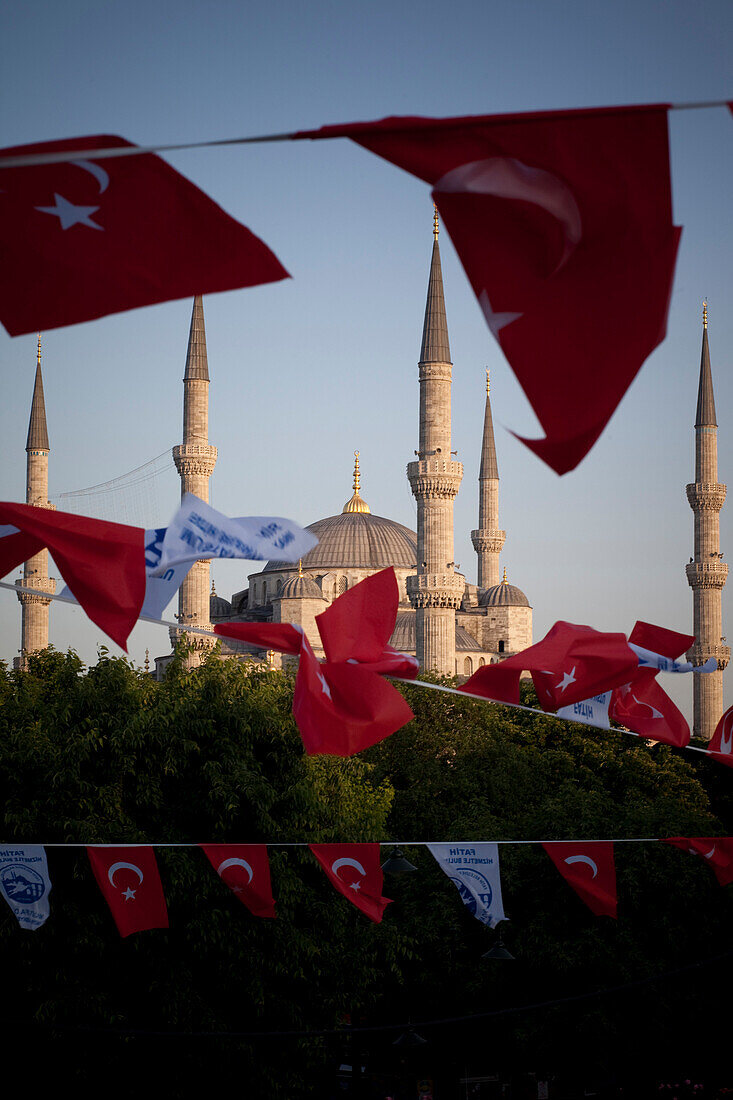 Turkish flags flap in the breeze at dusk over Blue Mosque, Sultanahmet, Istanbul, Turkey