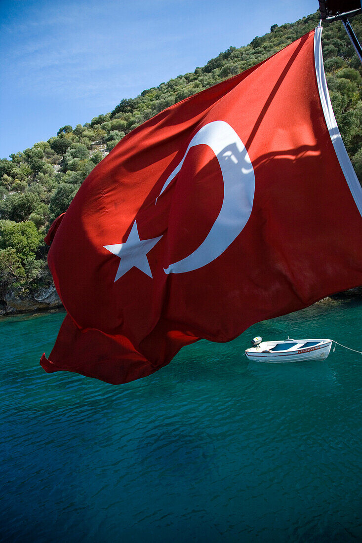 Small row boat moored in bay next to island, Fethiye Bay, Turkey