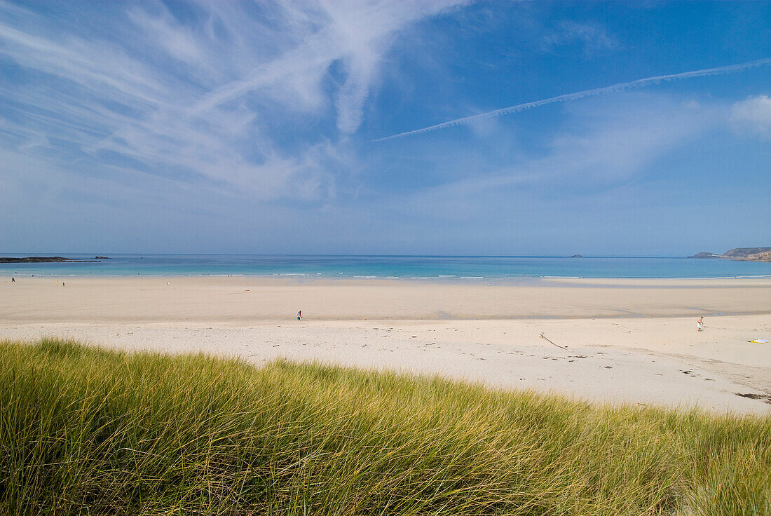 Looking over grassy dunes to the beach at Sennen Cove, Cornwall, England