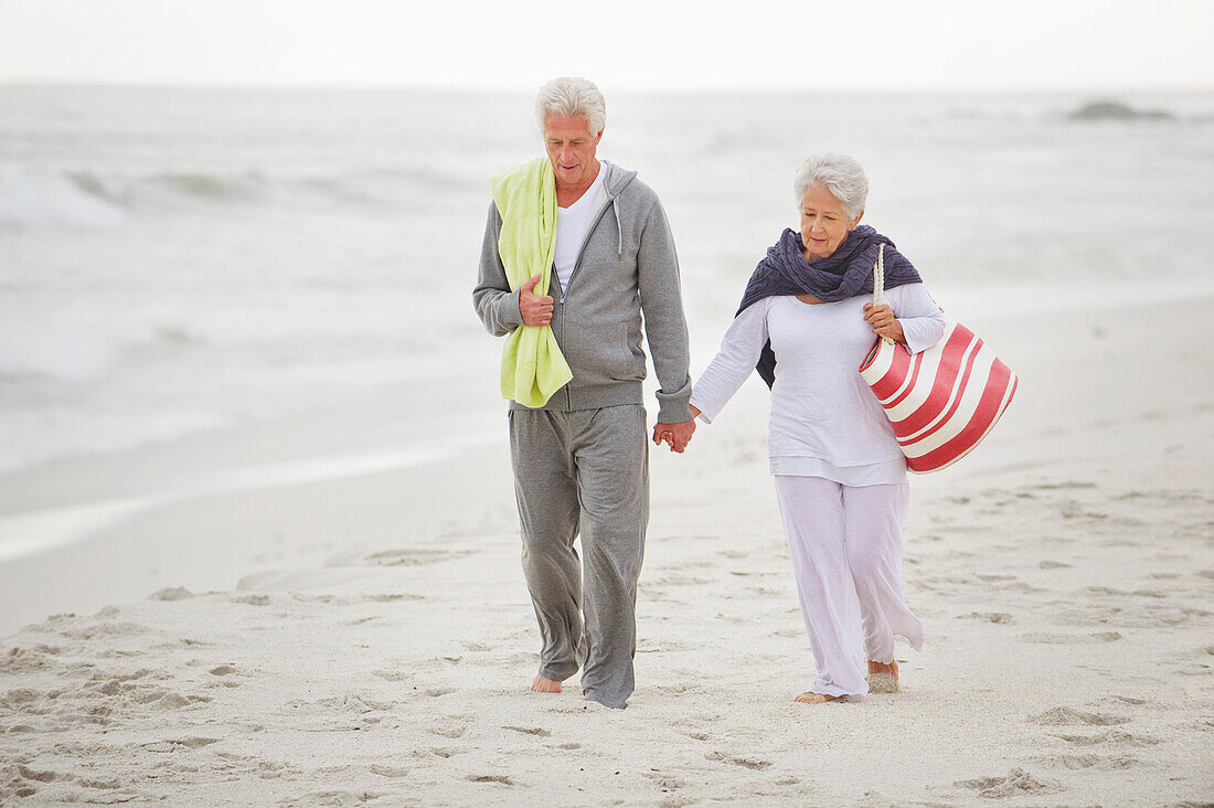 Senior couple walking on the beach