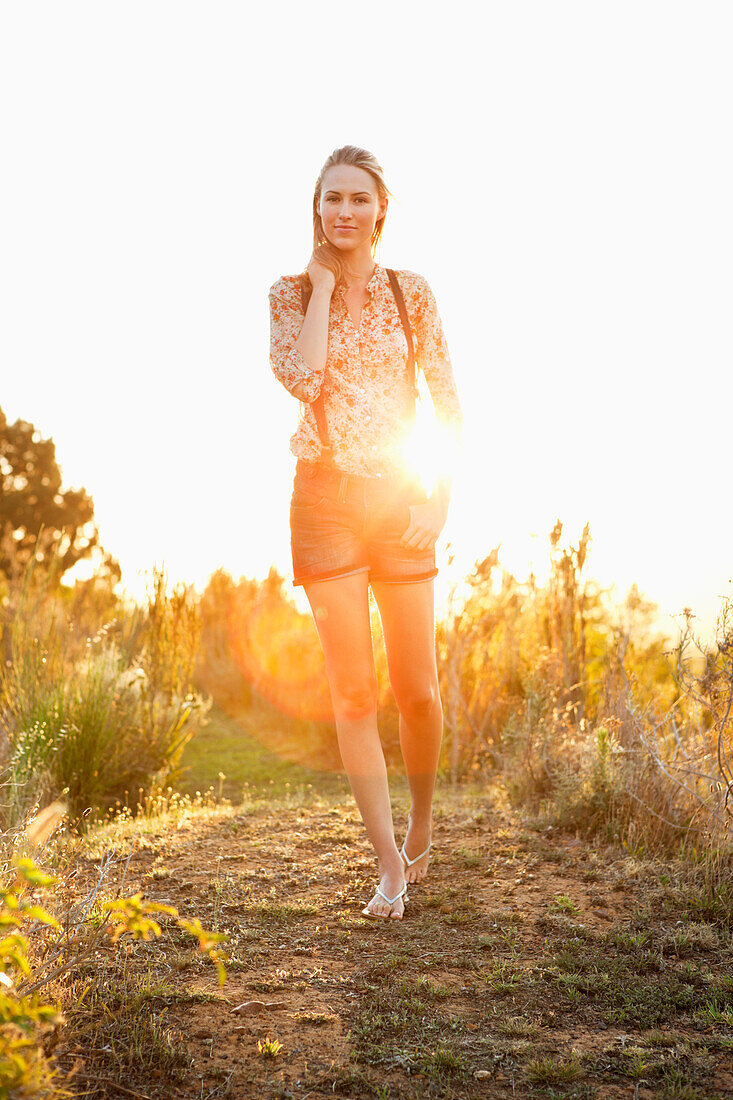 Beautiful woman walking on a trail and smiling