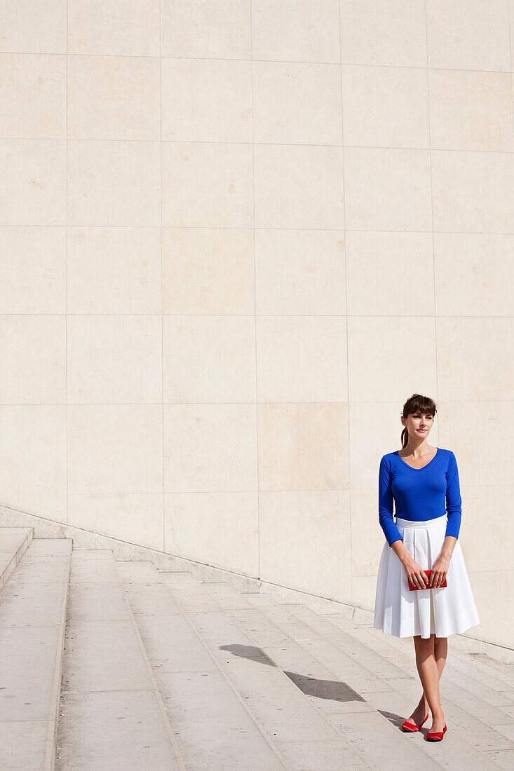 Woman standing on steps, Paris, Ile-de-France, France