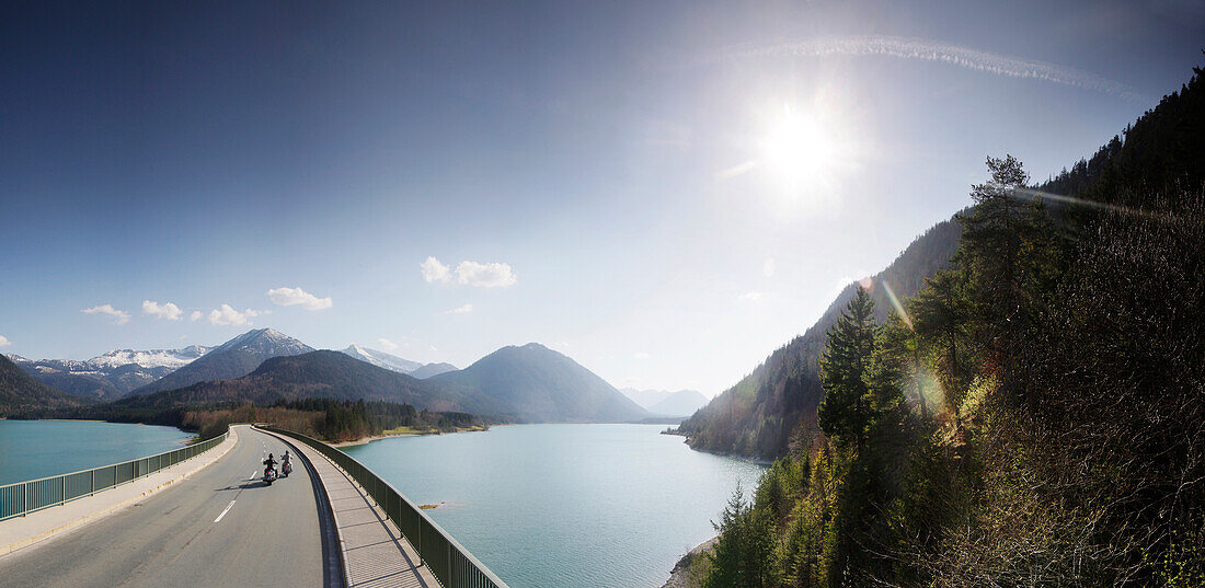 Motorbikers driving over the bridge at the Sylvenstein Reservoir, Motorbike tours around Garmisch, Upper Bavaria, Bavaria, Germany