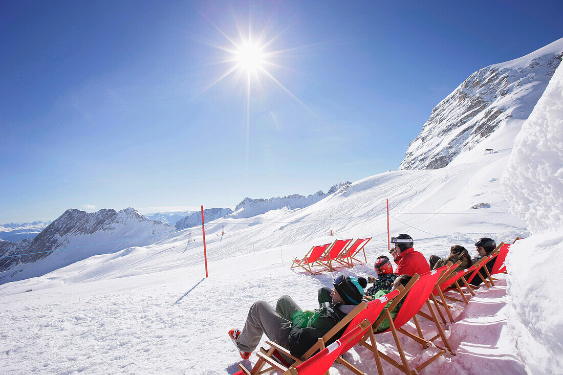 Guests sunbathing at the Igloo village, Sonnalpin Restaurant, View over the Zugspitzplateau, Zugspitze, Upper Bavaria, Bavaria, Germany