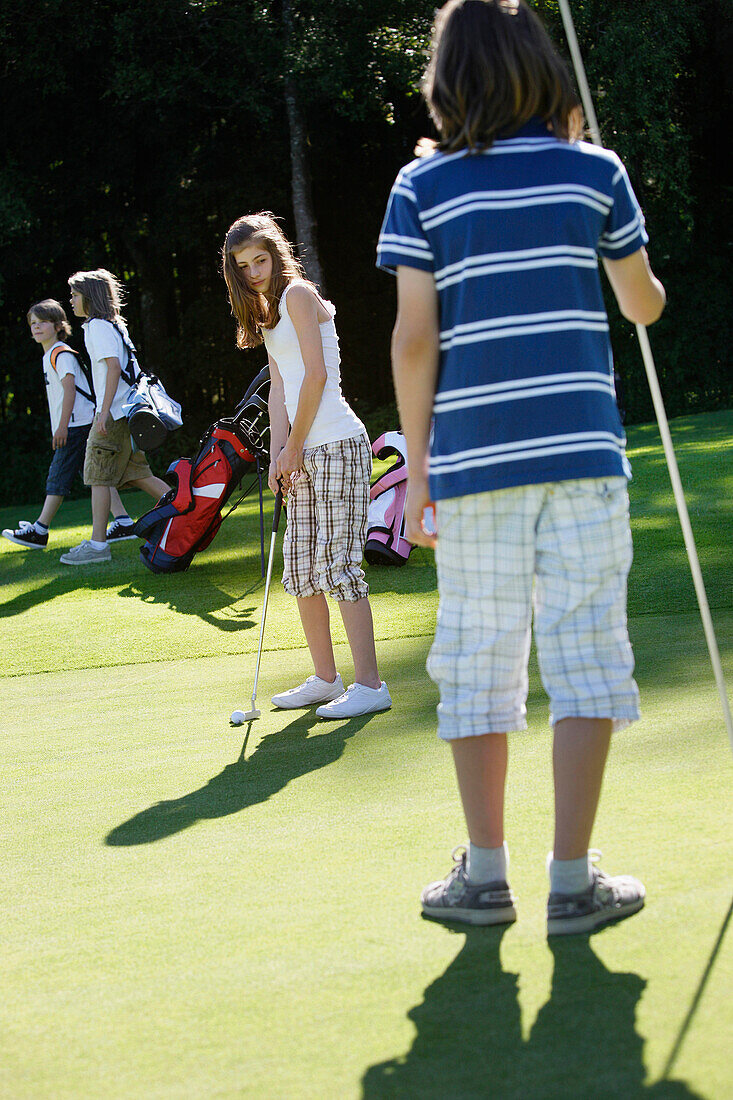 Children playing golf, Bergkramerhof, Bavaria, Germany