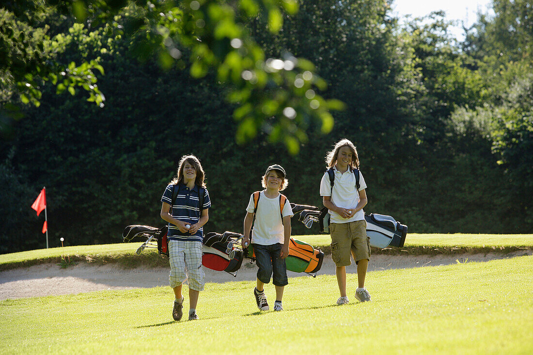 Children playing golf, Bergkramerhof, Bavaria, Germany