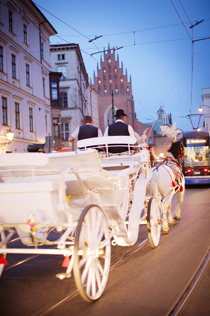 Horse-drawn carriage in the old town of Krakow at night, Franziskaner Street, Krakow, Poland