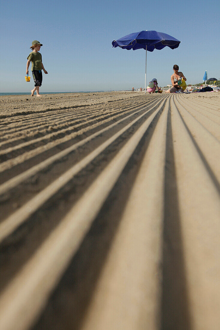 Mother with children on the beach in the morning, Lido di Venezia, Venice, Veneto, Italy