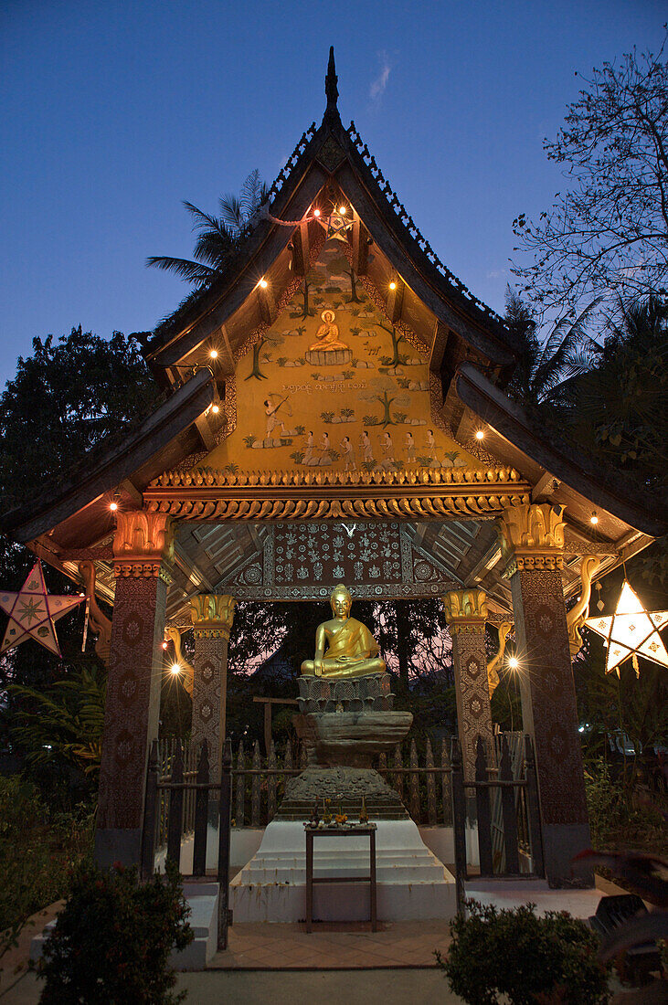 Sitting Buddha at evening at at Wat Xieng Thong, Luang Prabang, Laos