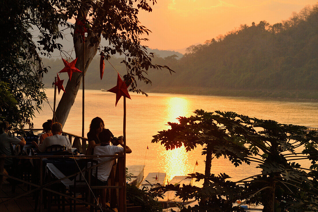 Restaurant overlooking Mekong river after sunset, Luang Prabang, Laos