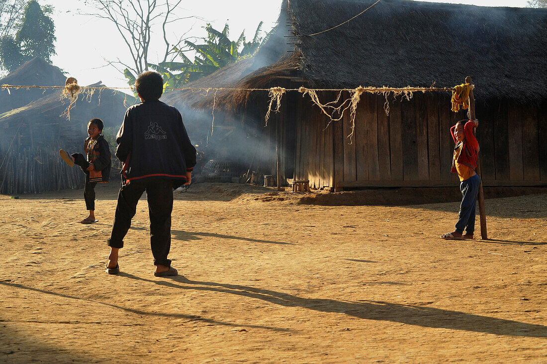 Children playing with traditional rattan ball in a village, Plain of Jars, Phonsavan, Xieng Khouang, Laos