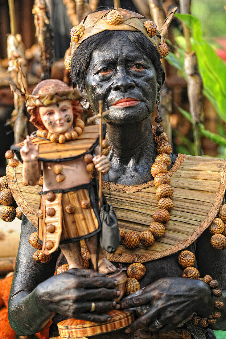 Old woman holding a Santo Nino figur, Ati Atihan festival, Kalibo, Aklan, Panay Island, Visayas, Philippines