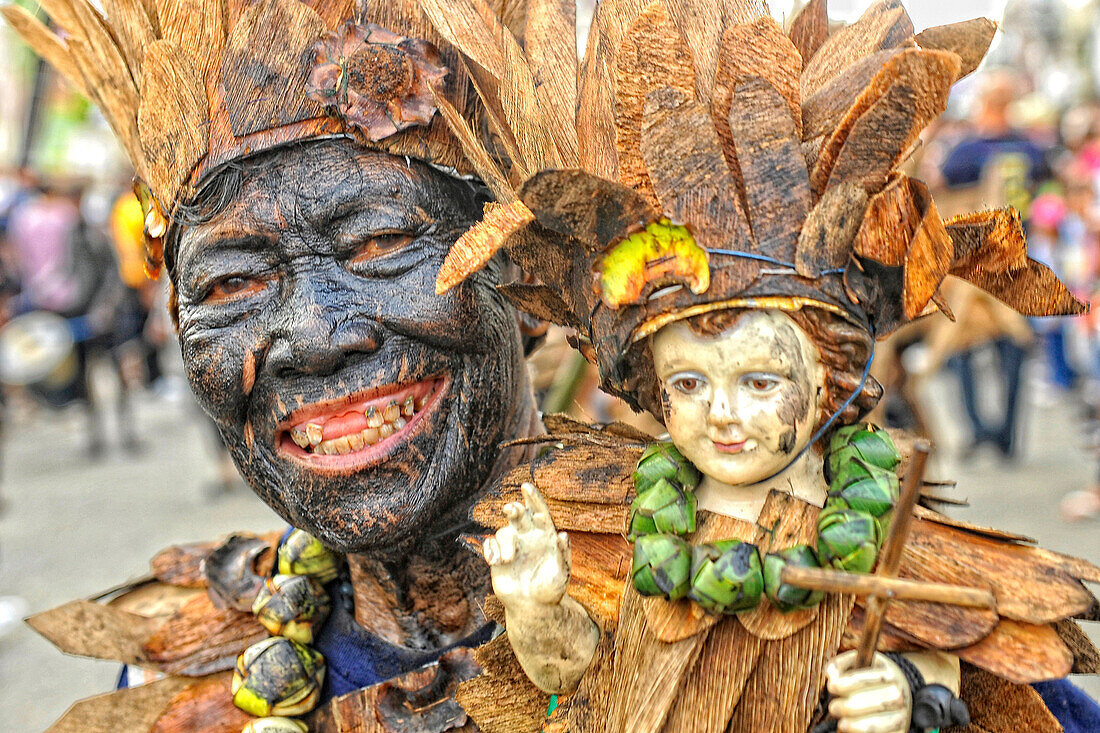 Toothless man holding a holy Santo Nino doll, Ati Atihan festival, Kalibo, Aklan, Panay Island, Visayas, Philippines