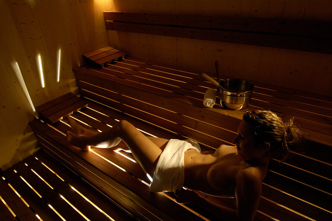 Young woman in a sauna, Moosmair hotel, Sand in Taufers, Val Pusteria, Alto Adige, South Tyrol, Italy, Europe