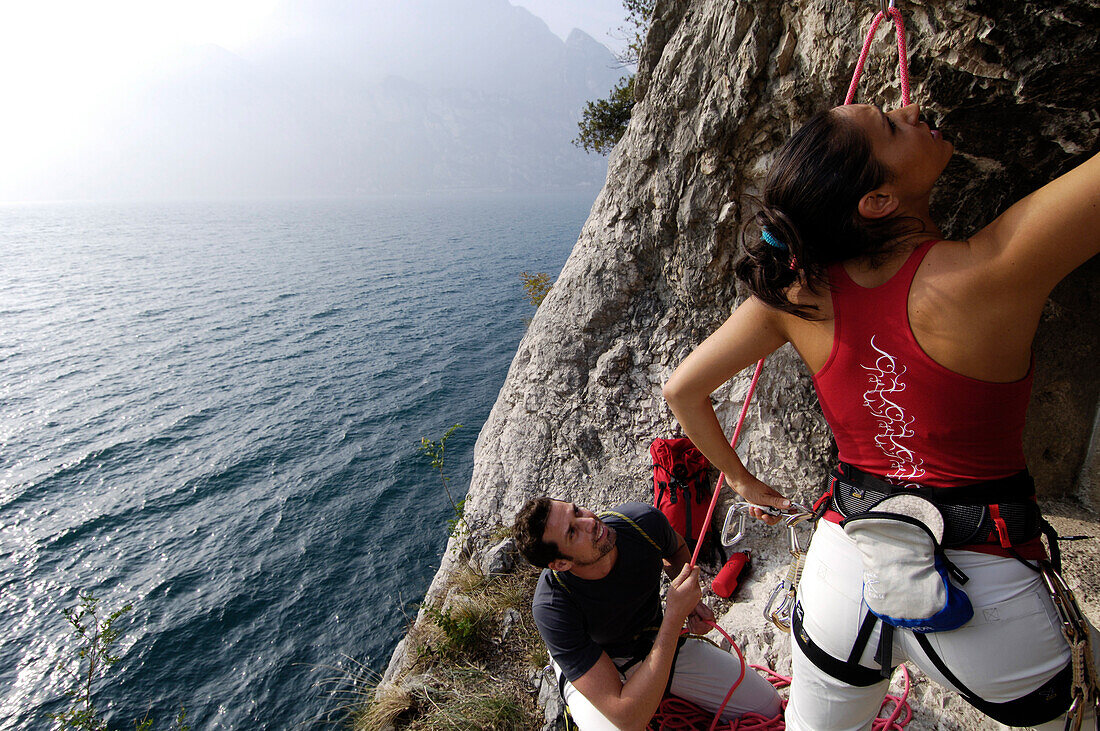 Two climbers at a rock face above lake Garda, Italy, Europe