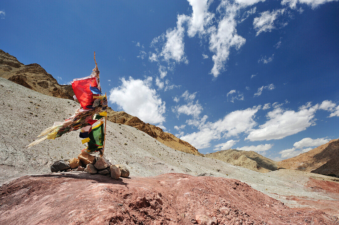 Prayer flags at pass, trekking from monastery of Likir to Yangtang, Ladakh, Jammu and Kashmir, India