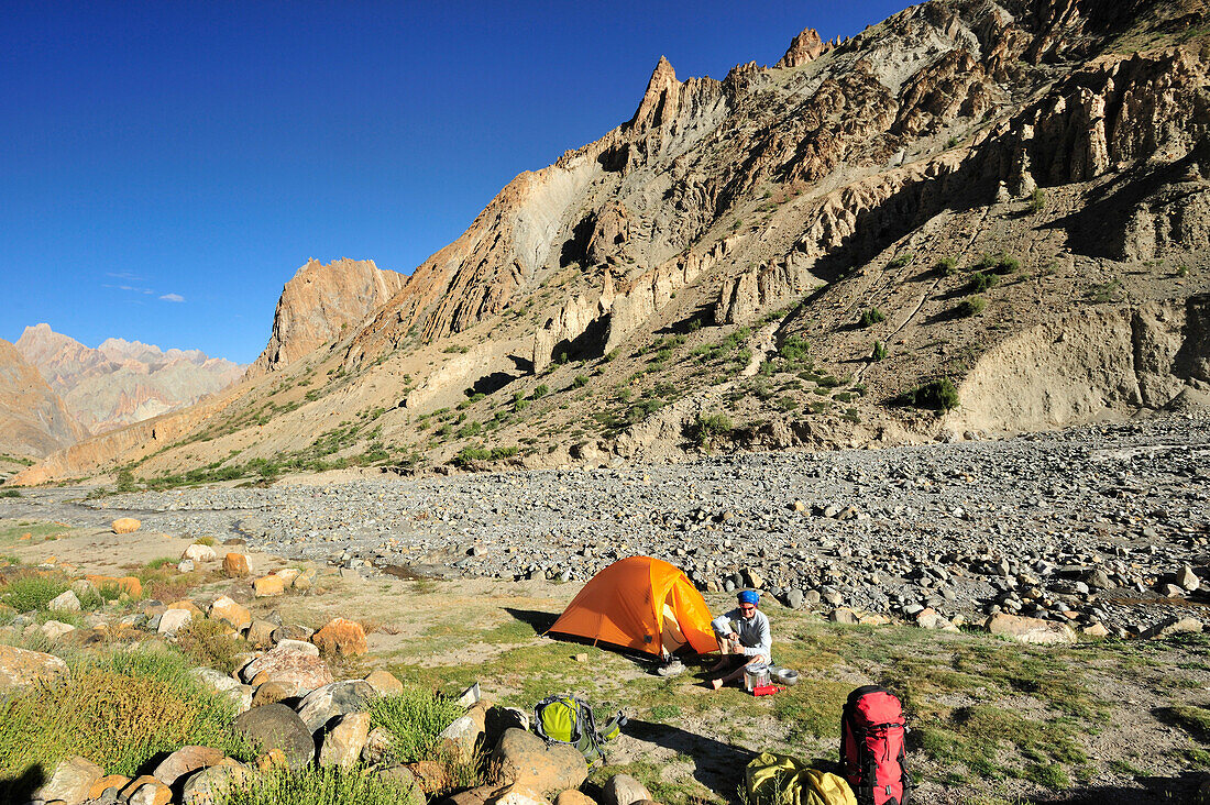 Woman sitting in front of tent, near village of Honupatta, Zanskar Range Traverse, Zanskar Range, Zanskar, Ladakh, Jammu and Kashmir, India