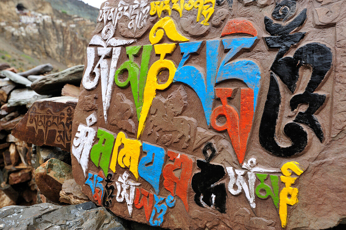 Colourful mani stones with monastery of Phuktal in background, Phuktal, Zanskar Range Traverse, Zanskar Range, Zanskar, Ladakh, India