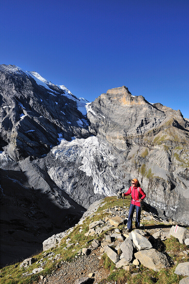 Woman ascending to Sefinenfurgge, Bluemisalp in background, UNESCO World Heritage Site Jungfrau-Aletsch protected area, Bernese Oberland, canton of Bern, Switzerland