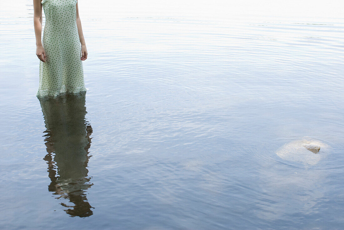Girl in Polka Dot Dress Standing in Water