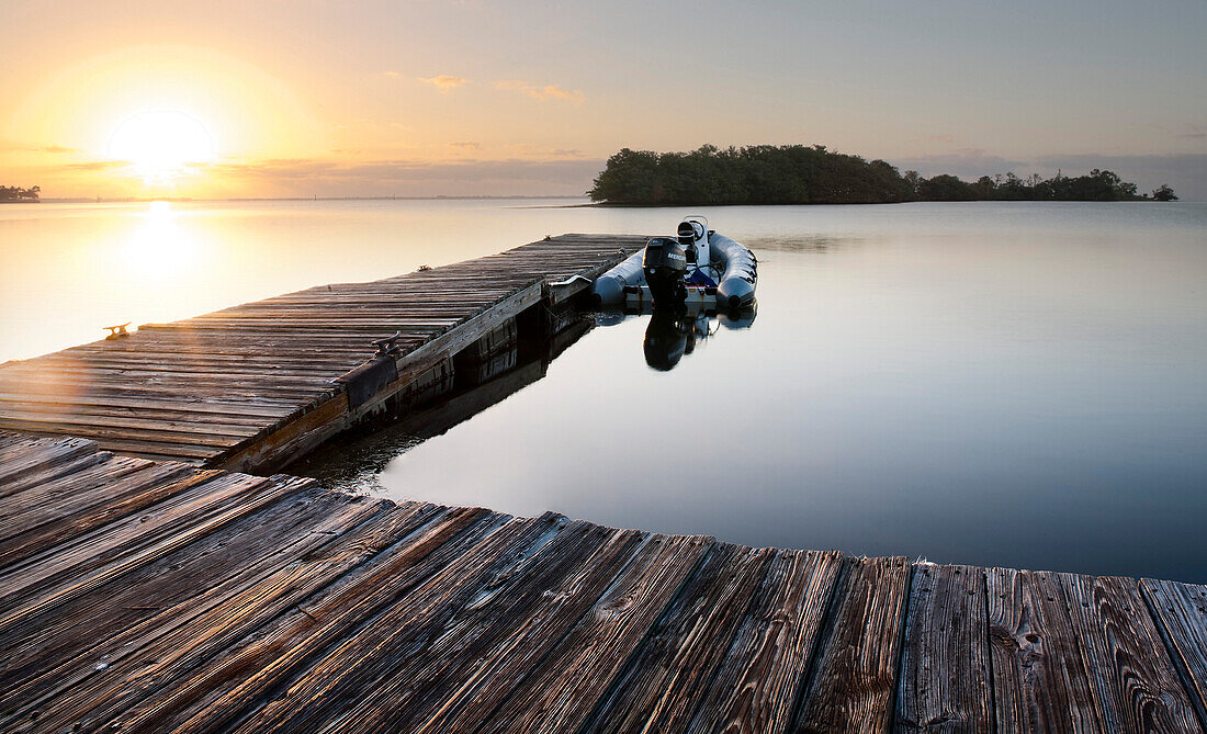 Motorboat and Dock at Sunrise, Florida, USA