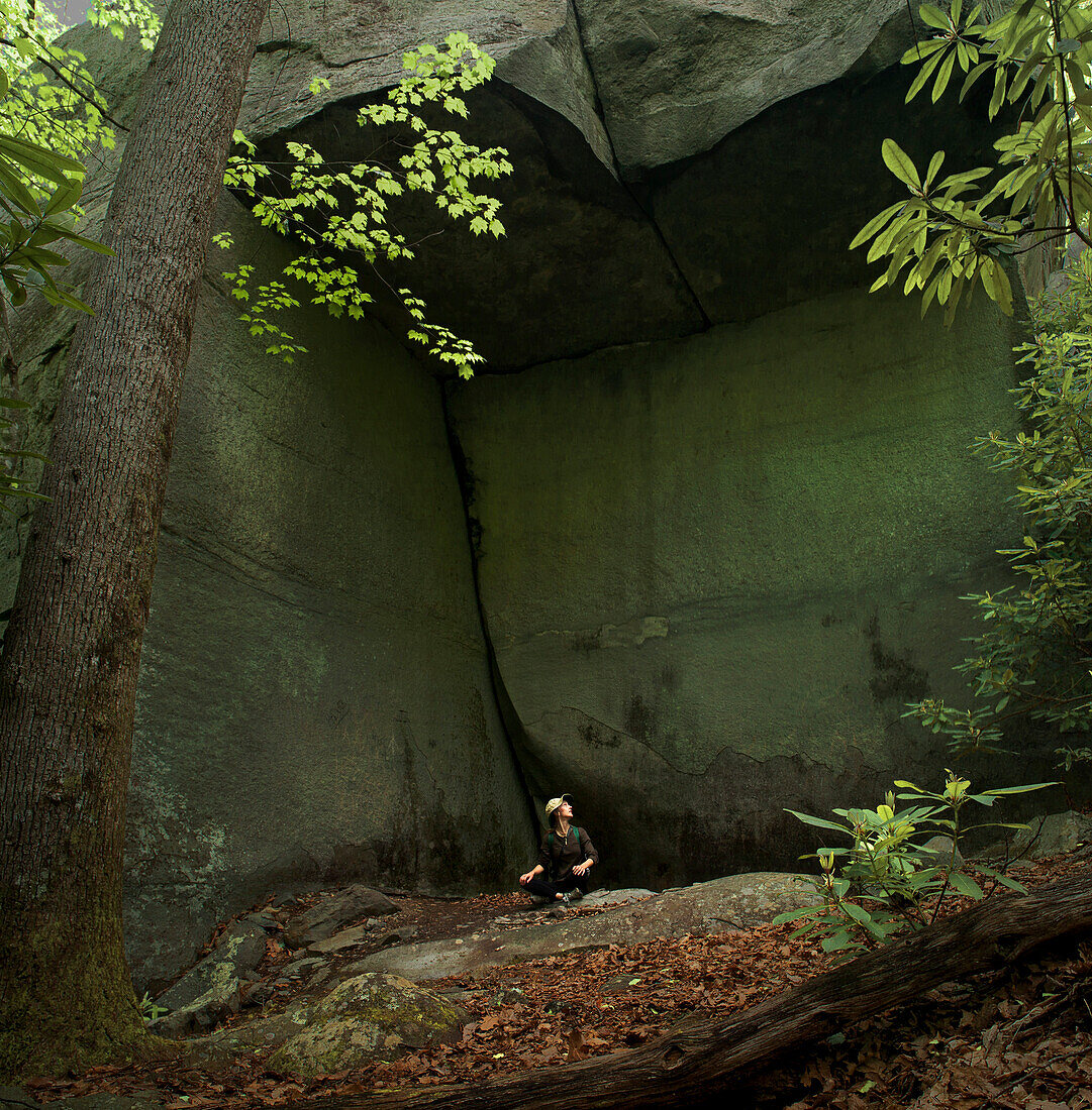 Woman Resting Under Natural Rock Shelter, Smokey Mountains, North Carolina, USA