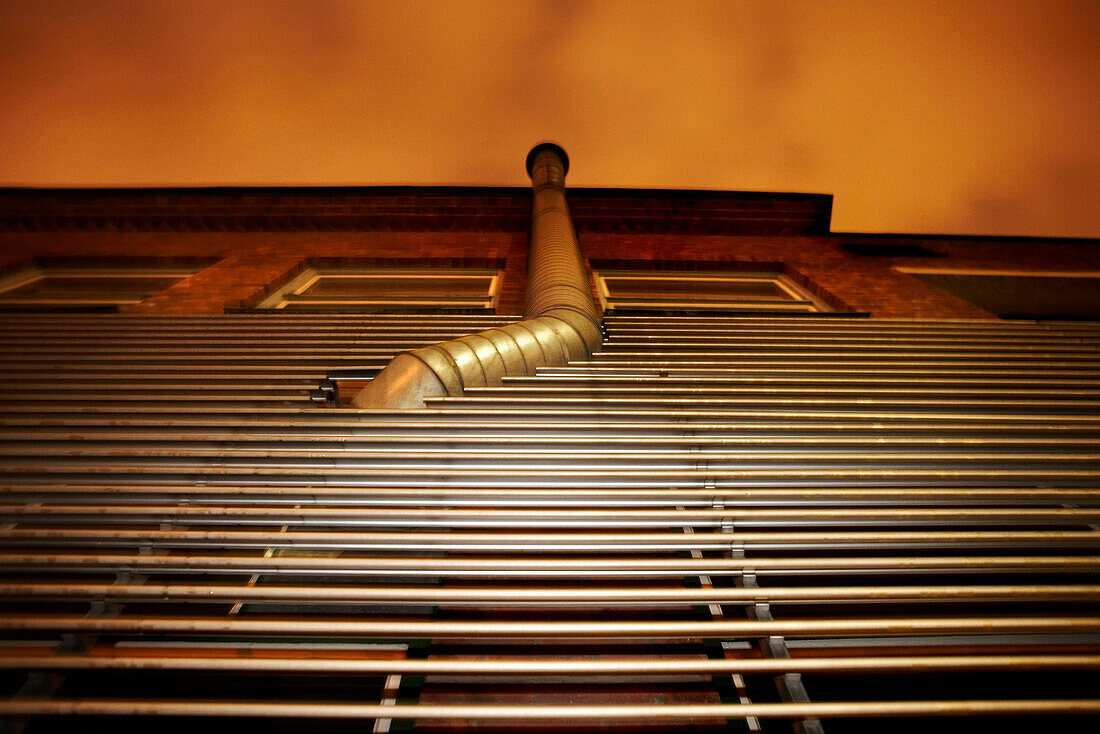 Metal Smokestack on Side of Building, Low Angle View