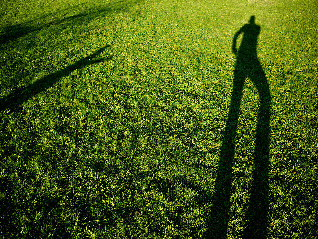 Human Shadow on Green Grass