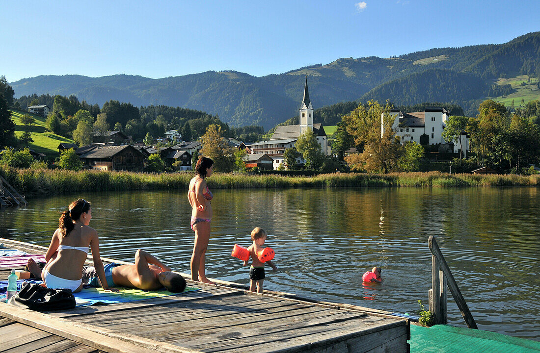 Children swimming in Lake Goldegg in Pongau, Salzburg-land, Austria