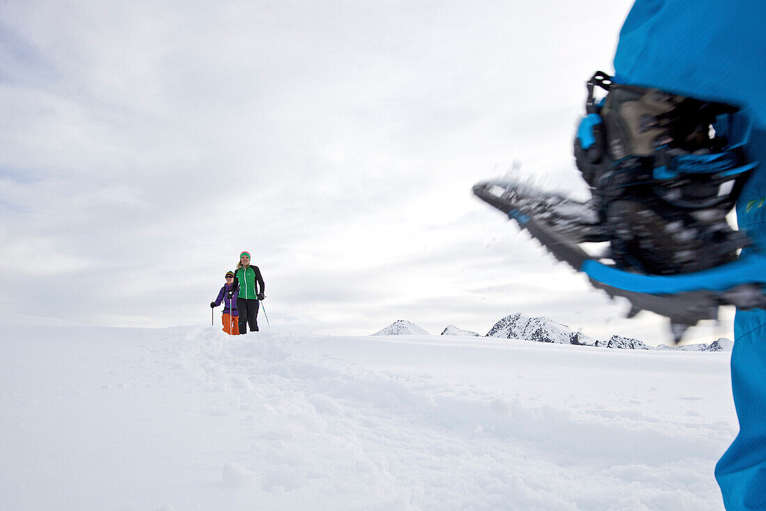 Junge Skifahrerinnen wandern mit ihren Schneeschuhen in den Bergen, See, Tirol, Österreich