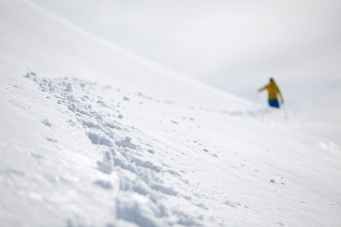 Young woman hiking up the mountain in snowshoes, See, Tyrol, Austria